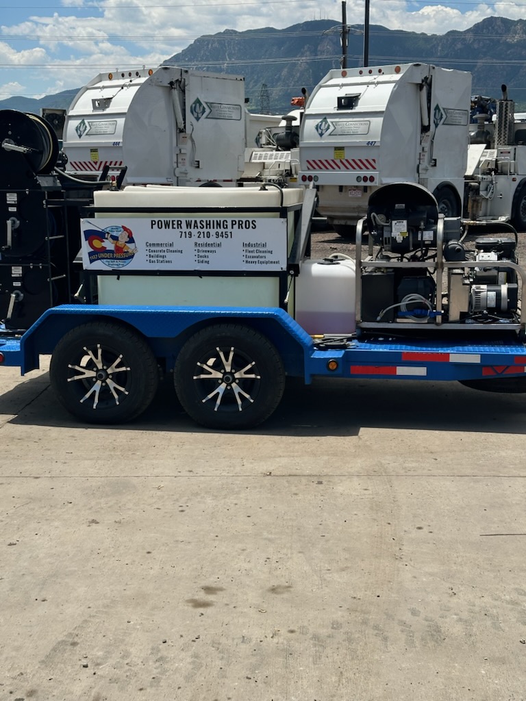 A pressure washing trailer with a commercial-grade washer, reels, and service banner for 'Power Washing Pros,' highlighting services for commercial, residential, industrial cleaning, and heavy equipment maintenance.