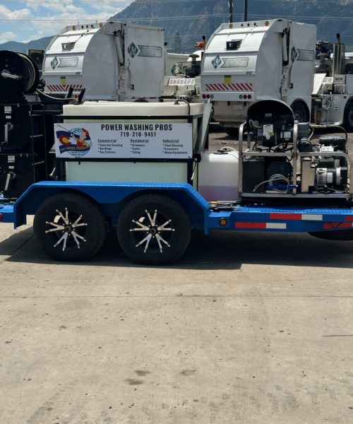 A pressure washing trailer with a commercial-grade washer, reels, and service banner for 'Power Washing Pros,' highlighting services for commercial, residential, industrial cleaning, and heavy equipment maintenance.